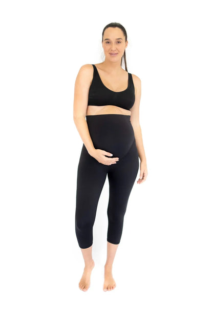 Pregnant woman in black athletic wear showcasing completely specialised maternity leggings