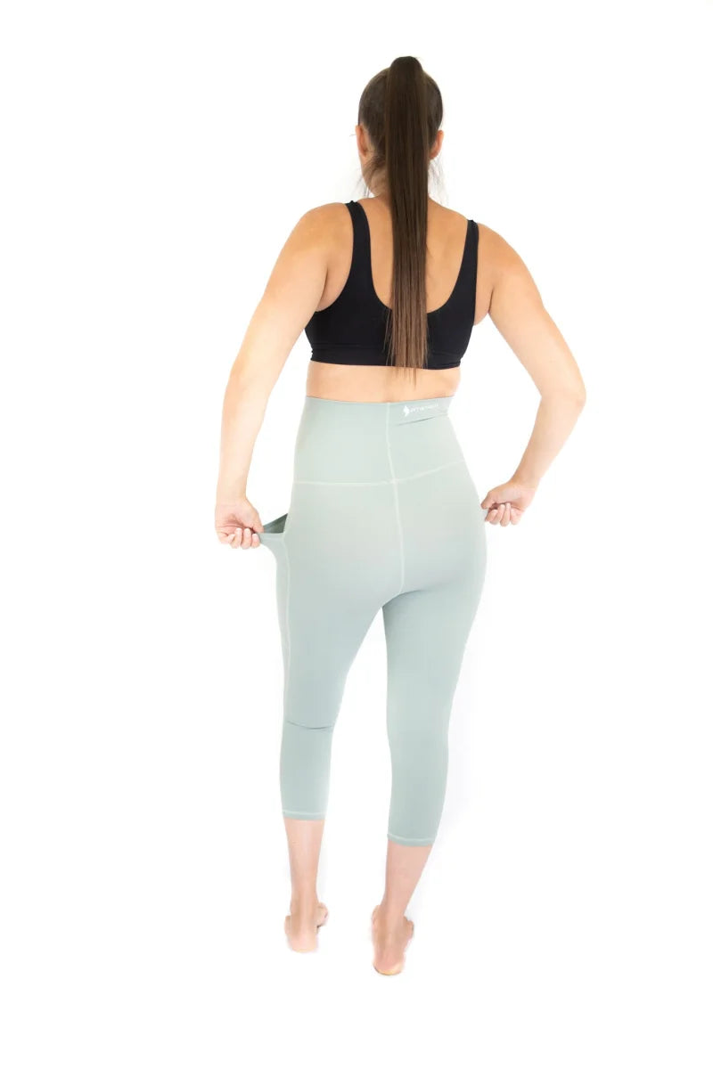 Woman in 3/4 Maternity Leggings with pockets, seen from behind, perfect for active moms