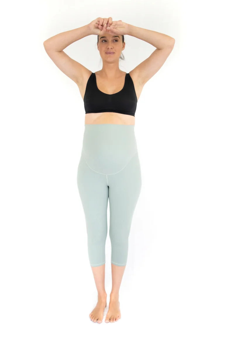 Woman in workout attire wearing completely specialised maternity leggings in spearmint