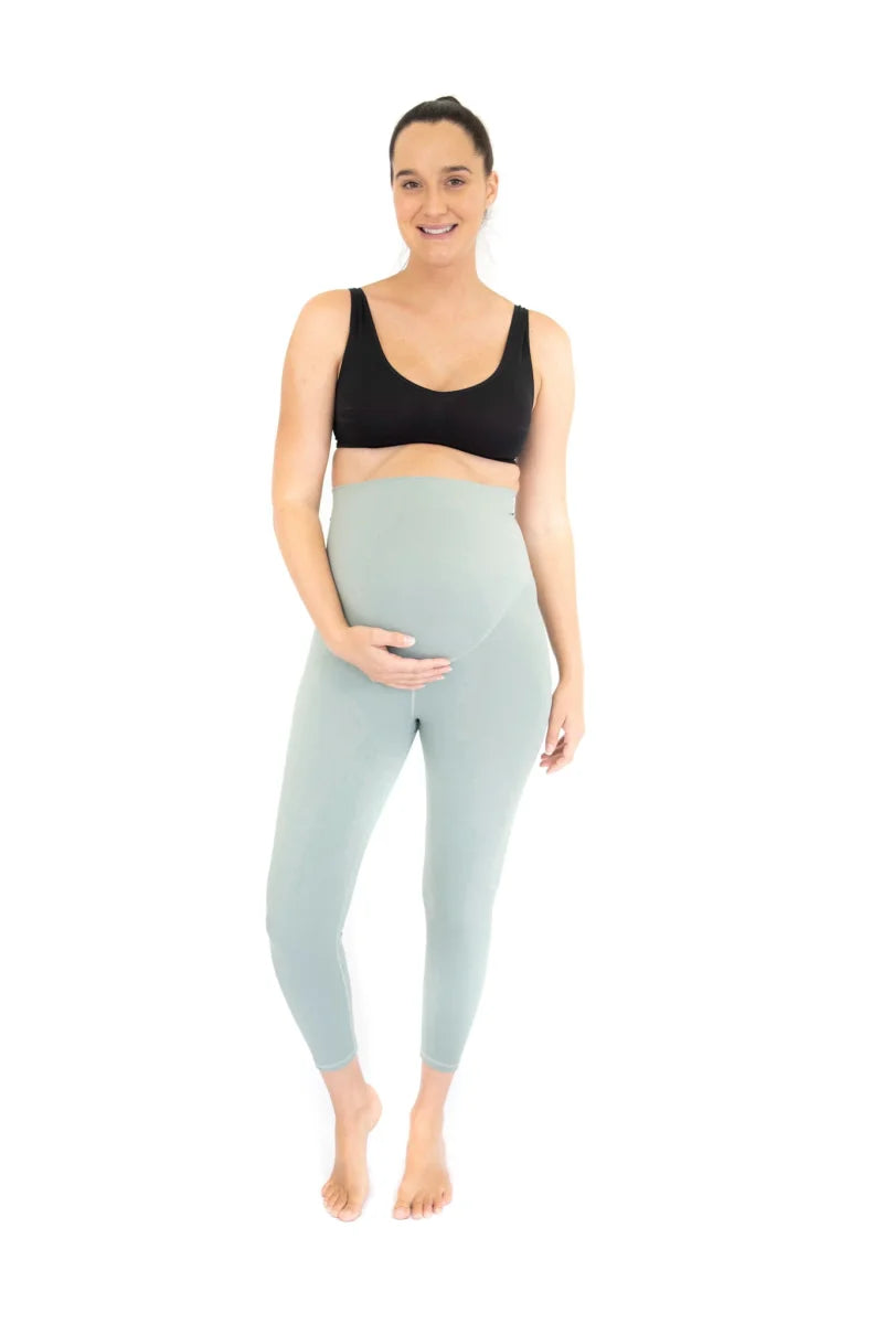 Pregnant woman in black sports bra and light blue Emamaco Maternity Leggings