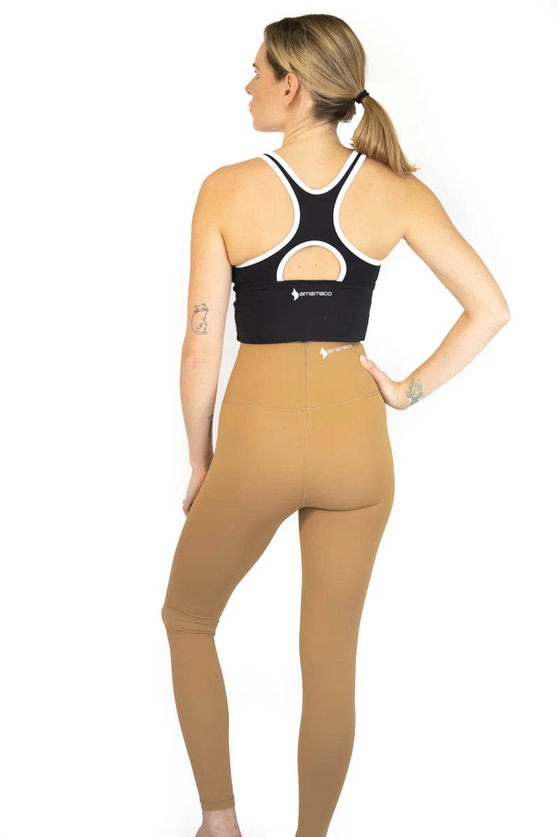 Woman in athletic clothing showcasing 7/8 Shaper Move Leggings on final sale