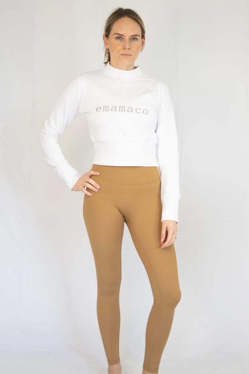 Woman in white crop top and tan leggings from 7/8 Shaper Move, limited sizes remaining