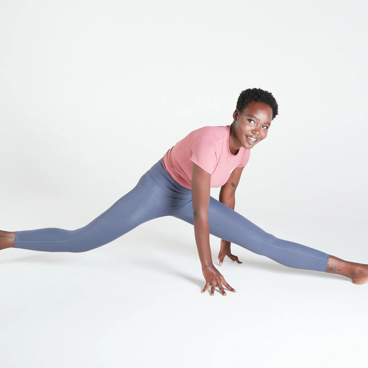 Woman in a yoga pose doing a wide-legged split in Twilight activewear leggings