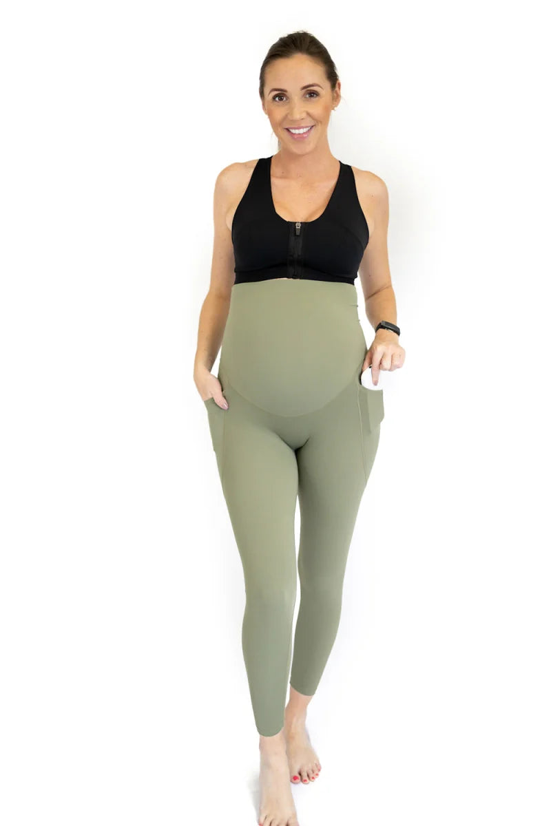 Woman in black sports bra and sage green Emama Maternity Leggings Full Length with Pockets