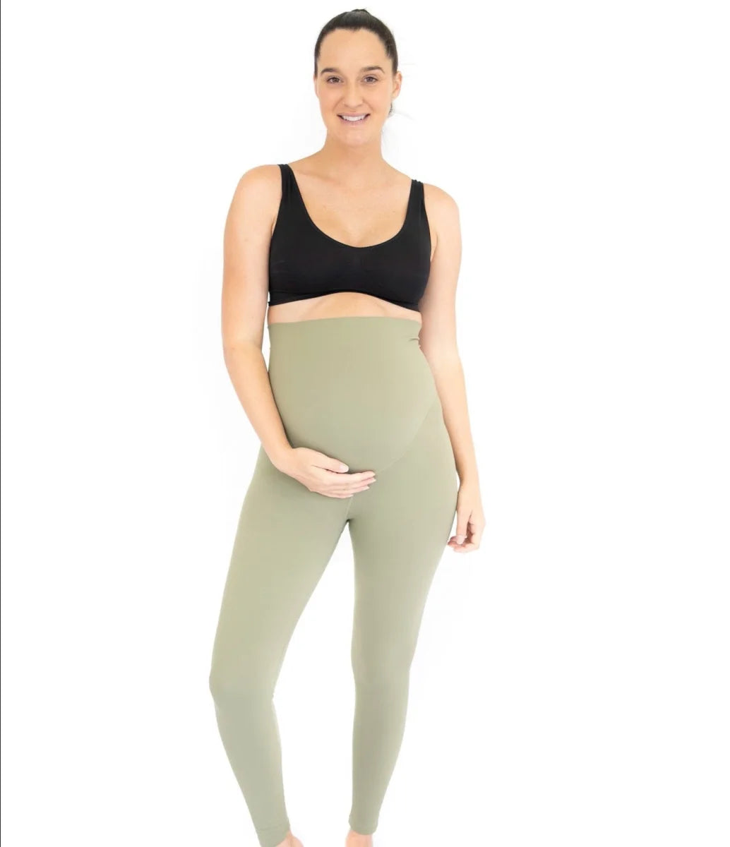 Pregnant woman in Emama Maternity Leggings, Olive, showcasing comfort and style