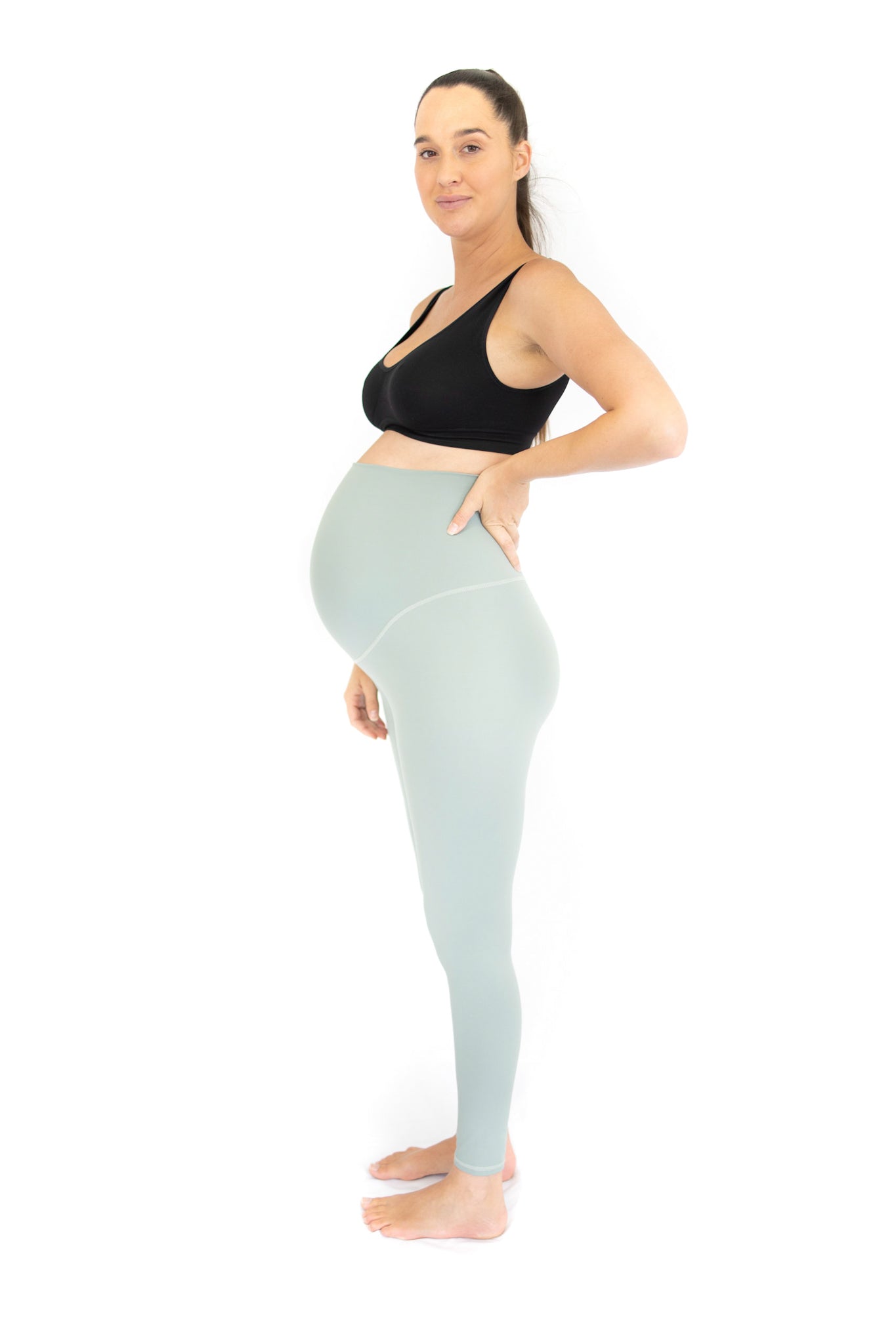 Pregnant woman in black sports bra and light blue Emama Maternity Leggings