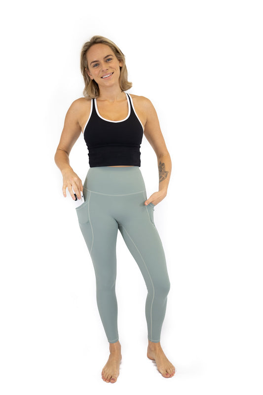 Woman in black tank top and light blue leggings from Shaper Move Final Sale collection