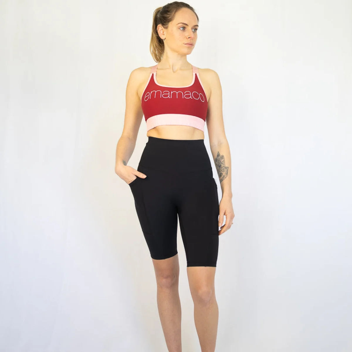 Woman in red sports bra and black long shorts perfect for maternity and pet hair care