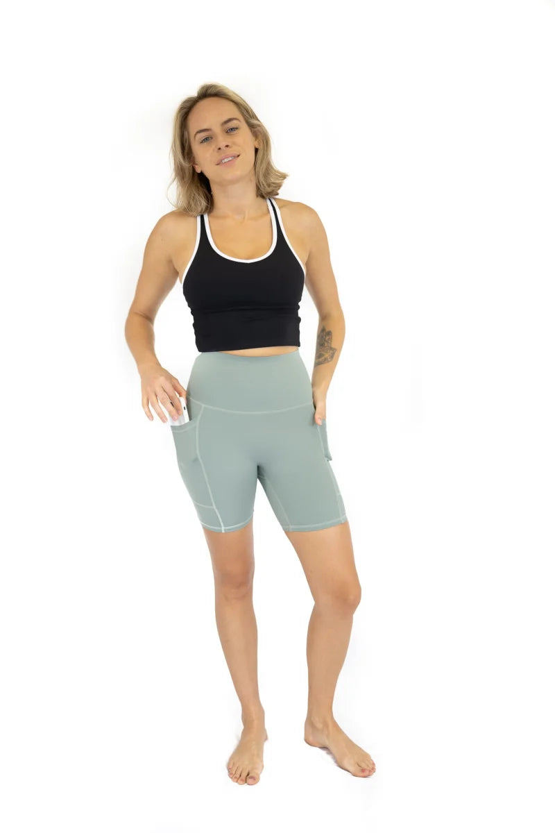 Woman in black tank top and light blue Shaper Move Shorts on final sale, limited sizes