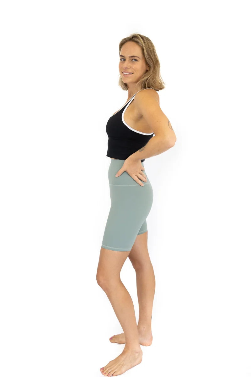 Woman in black top and light blue skirt modeling Shaper Move Shorts - Spearmint final sale