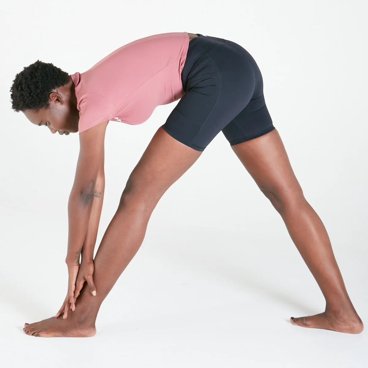 Person in standing forward bend wearing Vibe Shorts with regular fit waistband