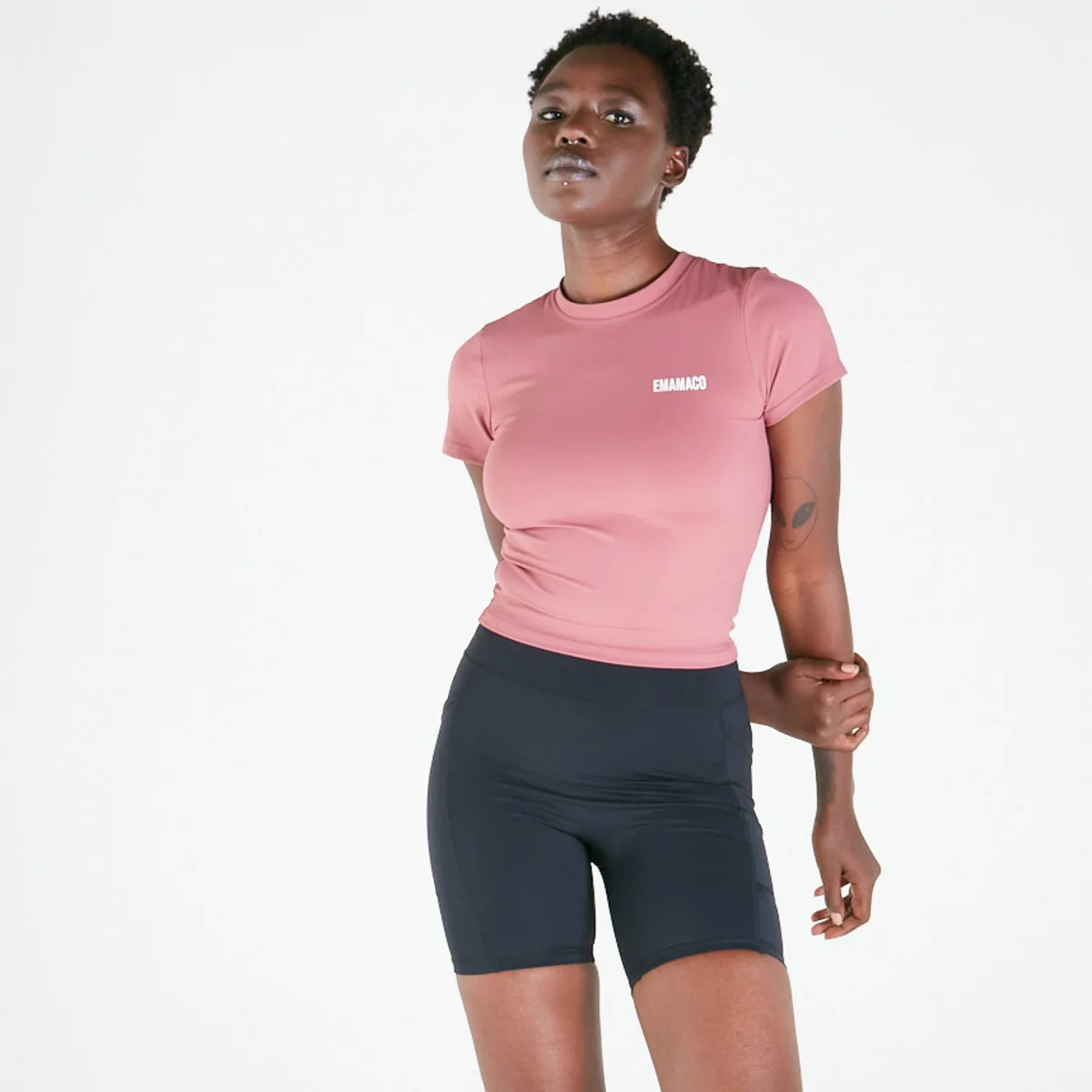 Person in pink t-shirt and dark shorts showcasing Vibe Shorts with regular fit waistband