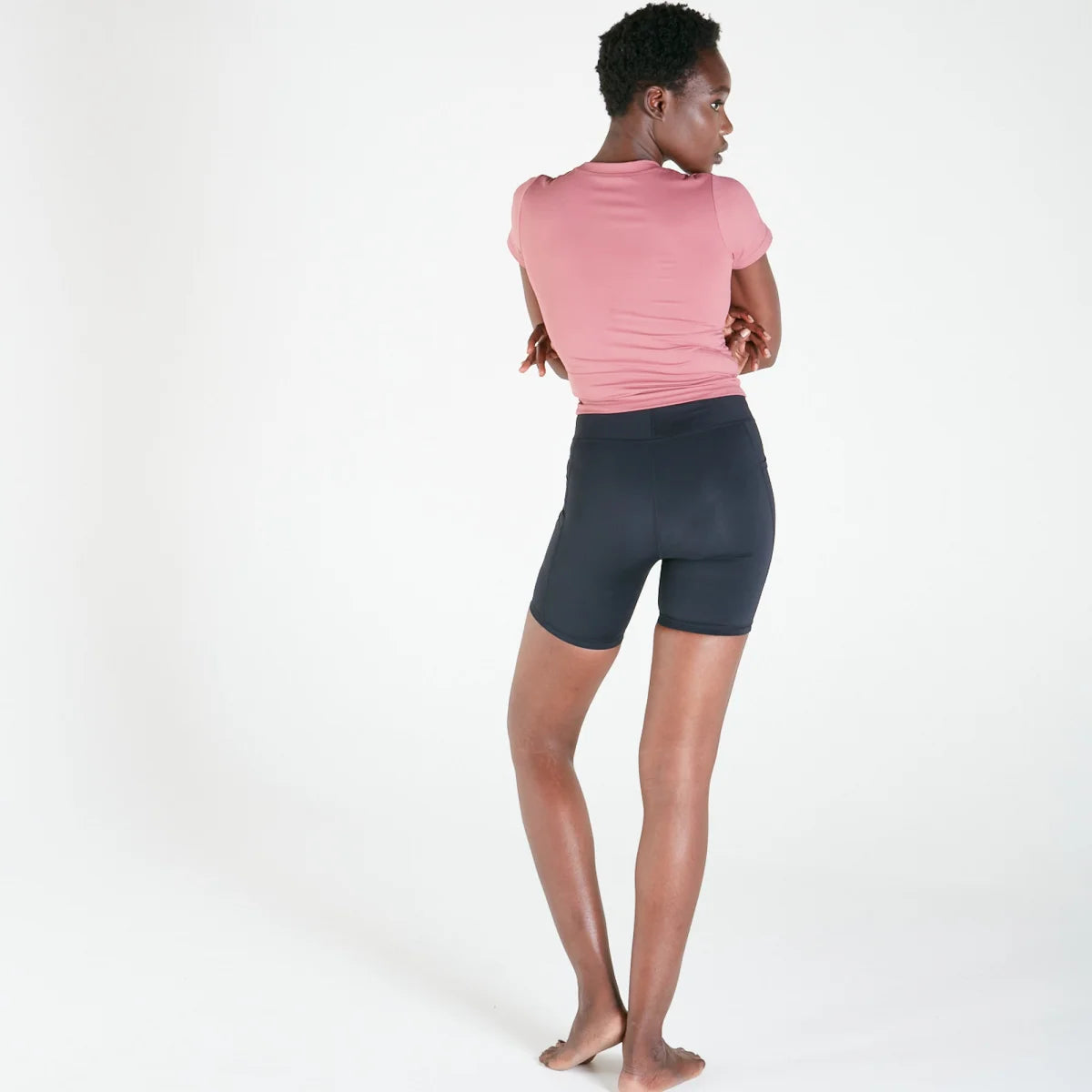 Woman modeling Vibe Shorts with pockets in Black, featuring a regular fit waistband